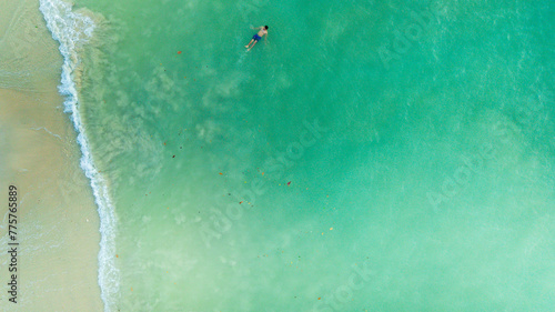 Aerial view of person swimming in transparent sea on Kapas Island on Kuala Terengganu, Malaysia. photo