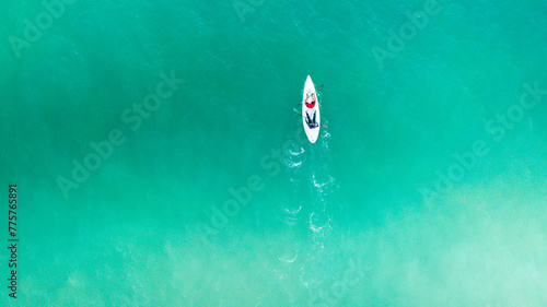 Top view of kayak boat oin shallow turquoise water of Kapas Island sea, Kuala Terengganu, Malaysia.