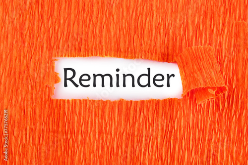 reminder word on a white sheet under an orange background