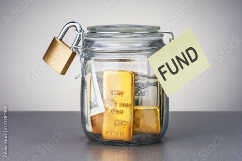 Money and gold bars for emergency fund in the glass jar. Concept financial security.