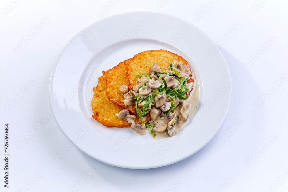 potato pancakes with mushrooms on white plate potato pancakes with mushrooms on white plate