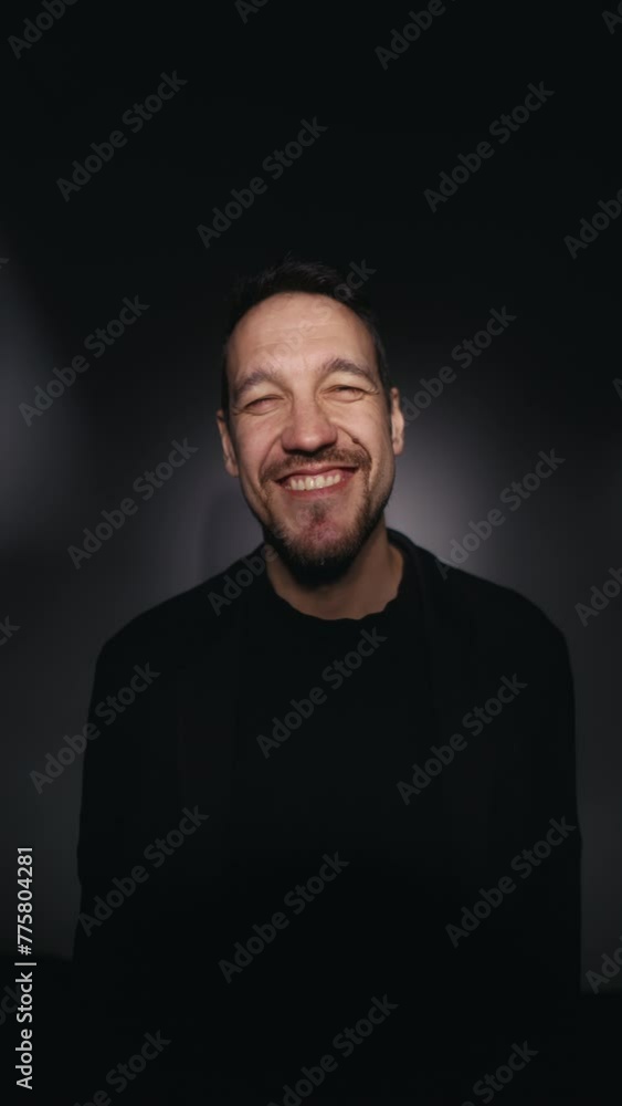 Blissful chuckle: Bearded gentleman in sleek black suit jacket laughs joyously, eyes squeezed shut in merriment Blissful chuckle: Bearded gentleman in sleek black suit jacket laughs joyously, eyes squeezed shut in merriment