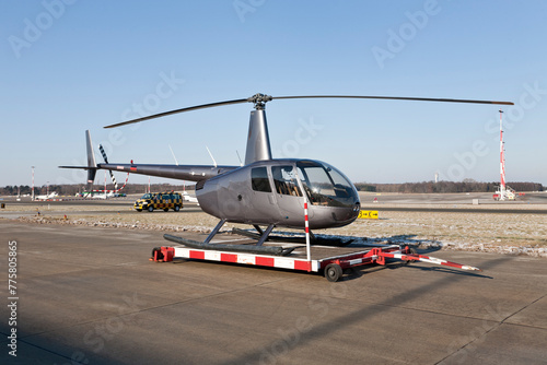 helicopter on the airfield at airport in front of blue sky