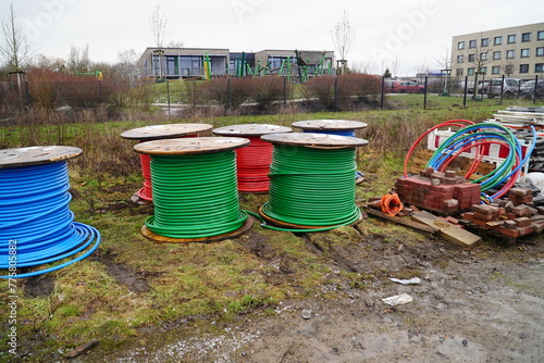 Rolls of colorful fiber optic cable for laying in the ground, underground cables for faster internet in rural region, near the city of Garbsen, district of Hanover, Lower Saxony, Germany