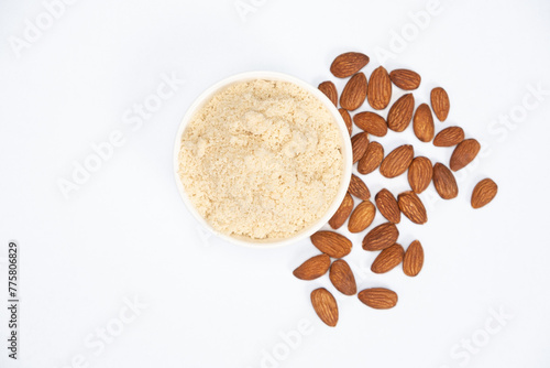 Almond flour and almonds on a white background top view