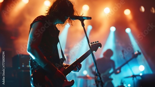 Energetic rock musician playing electric guitar on stage with vibrant lights in live concert performance. Music and entertainment.