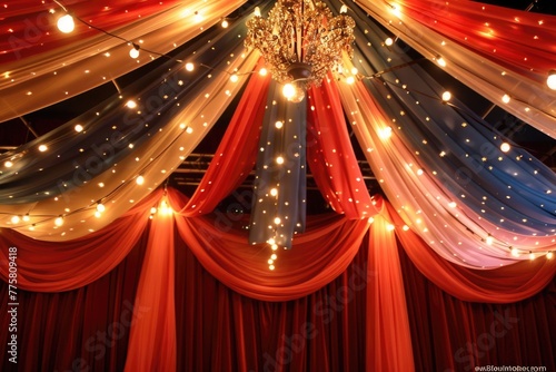 Chandelier with multicolored drapery and string lights.