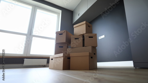 Lot of cardboard boxes on wooden floor new flat closeup background. Fast banking credit concept © H_Ko