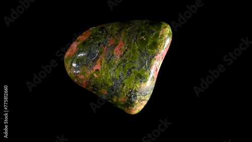 Polished Unakite -  metamorphic granite composed of orthoclase feldspar, epidote and quartz - rotating slowly against a black background.