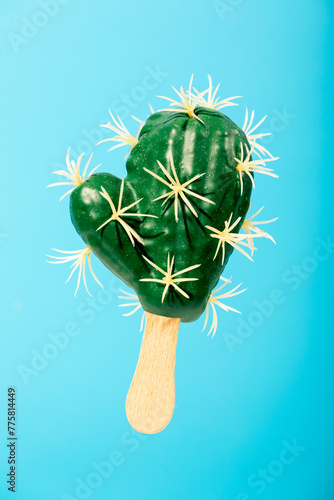 Cactus-shaped popsicle on a blue background photo