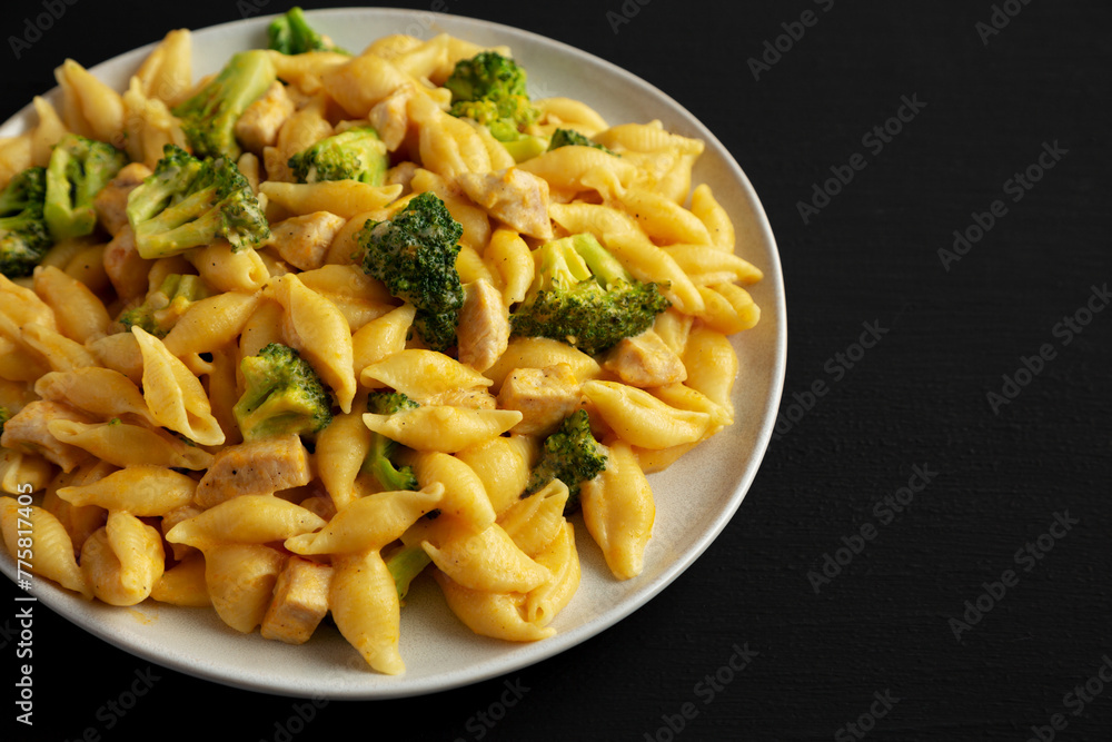 Homemade Cheesy Chicken And Broccoli Pasta on a Plate, side view. Homemade Cheesy Chicken And Broccoli Pasta on a Plate, side view.
