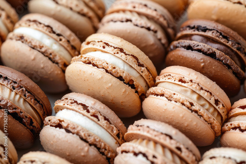 Close-up of tasty beige macaroons arranged in a row 