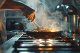 A cook frying something in a wok at a pan on a gas stove, close-up of a hand with smoke. copy space
