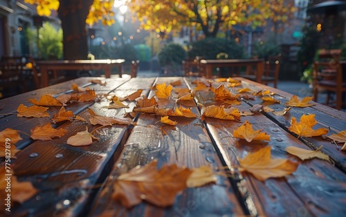 A table covered in autumn leaves. The leaves are scattered all over the table and the ground. Scene is peaceful and serene  as the leaves fall gently from the trees and create a beautiful scene