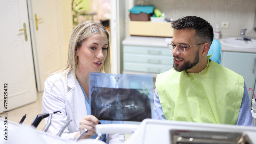 Young man making the treatment plan with his dentist Young man making the treatment plan with his dentist