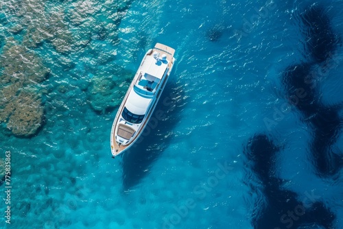 aerial view of a luxury yacht gracefully cruising the clear blue waters, an unparalleled experience of sea exploration