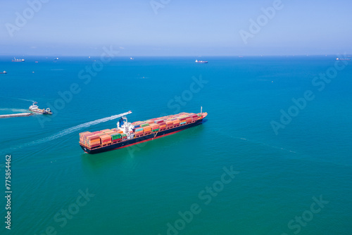 the image provides a stunning aerial view of a bustling cargo ship port, where massive vessels dock and unload their precious cargo.