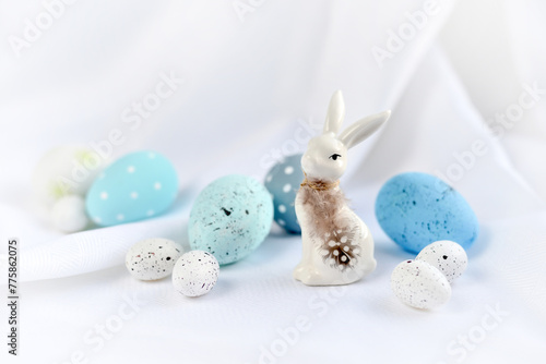 Easter composition with white rabbit and eggs on a white background. The minimal concept.