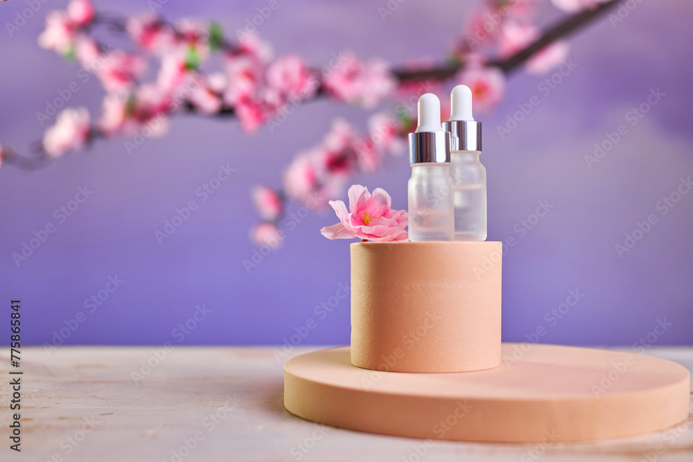 Glass bottle with pipette and serum on a podium Glass bottle with pipette and serum on a podium