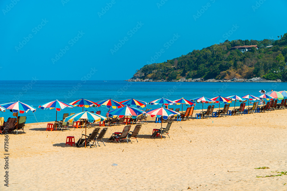 Karon Beach, one of the favorite beaches visited by tourists to play in the water, sunbathe or just enjoy the tropical climate in Phuket, Thailand. The beauty of Karon beach on a hot day