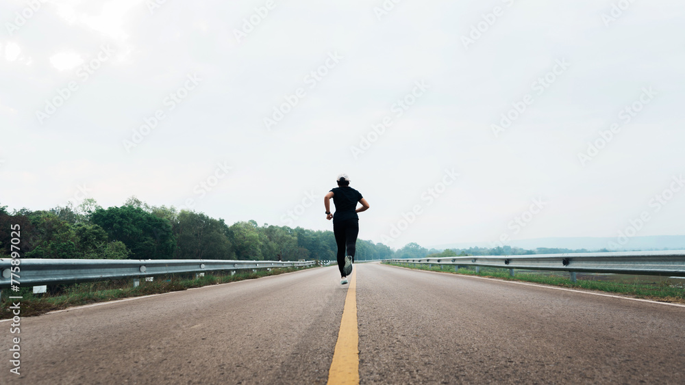 Women running on the road sets new goal to start running exercise, selective and soft focus.