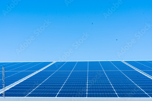 Solar cell panels against clear blue sky background, concept of sustainable resources and renewable energy, Copy space.