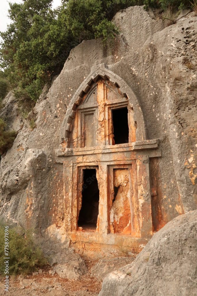 Ancient Lycian rock hewn, rock cut tomb above the coastal town of Kas, Turkey Ancient Lycian rock hewn, rock cut tomb above the coastal town of Kas, Turkey