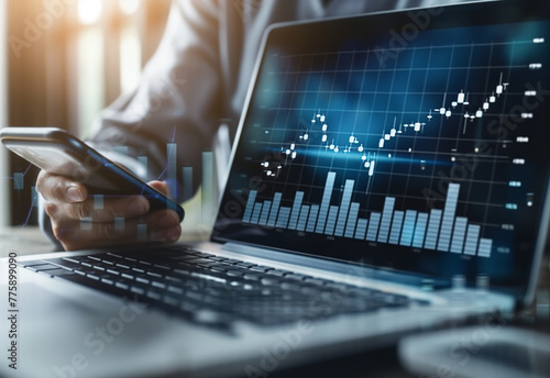 Digital Investor: Businessman Monitoring Stock Market Graphs on Mobile and Laptop Screens