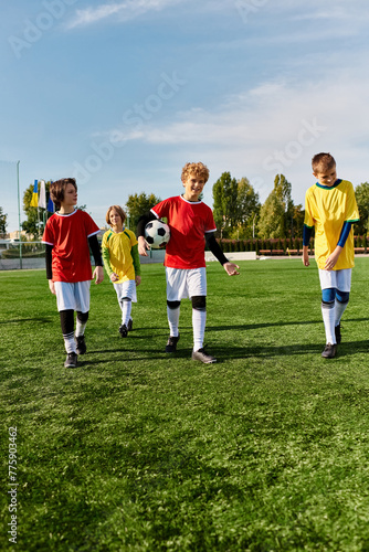 A diverse group of enthusiastic young boys stand proudly at the top of a soccer field, looking out at the horizon with determination and joy after a game.