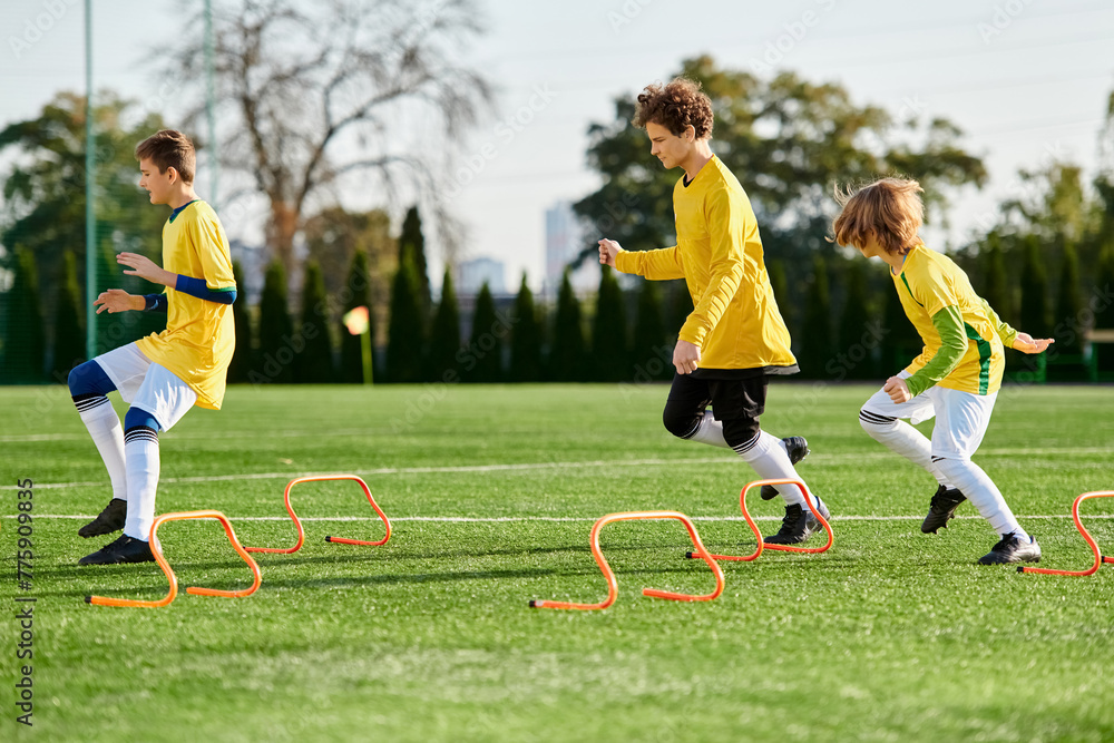 Obraz premium A lively group of young children joyfully engage in a spirited game of soccer, running, kicking, and passing the ball on a grassy field. 
