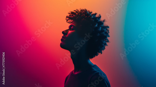 Silhouette of a Young Man Against a Vivid Red and Blue Gradient Background
