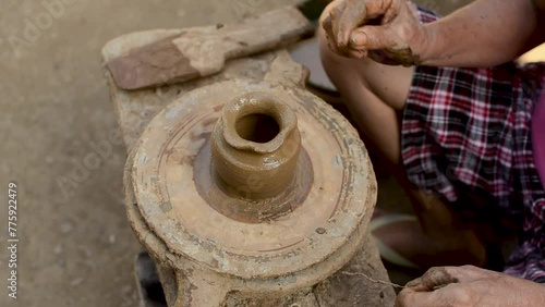 Close-up of hands crafting a clay pot, showcasing the art of traditional pottery in Barangay Cagbang, in the town of Miagao Iloilo, Philippines.