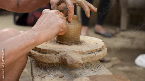 Close-up of hands crafting a clay pot, showcasing the art of traditional pottery in Barangay Cagbang, in the town of Miagao Iloilo, Philippines. photo