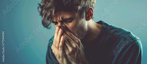Stressed man holding face and mouth photo