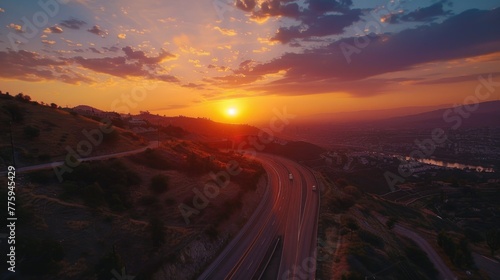 Scenic view of sun setting over a winding road, perfect for travel and nature concepts