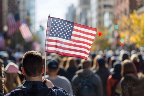 A man raising American flag in a crowd on the street