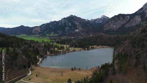 View of castle Neuschwanstein from alpine lake Schwansee In spring. Schwansee im Ostallgau in Bayern sudostlich von Fussen im Gemeindegebiet von Schwangau. Schloss Neuschwanstein und der See.  photo