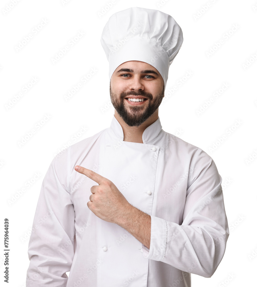 Happy young chef in uniform pointing at something on white background