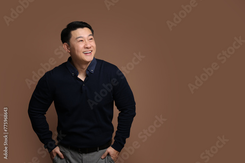 Portrait of happy man on brown background. Space for text