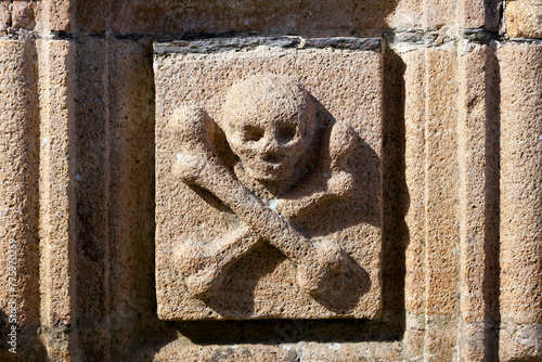 The Skull and bones sculpted on the ossuary of the Saint-Yves church in La Roche-Maurice