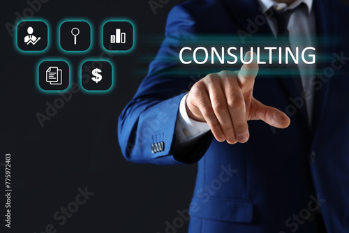 Consulting. Businessman using digital screen with icons on dark background, closeup