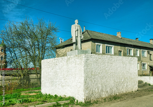 Monument to Lenin in front of Trinity bell tower (1870). Lenin is atheist, dialectical materialist, struggled with religion, as it turned out, only temporary success. Krasny Kholm, Tver Region, Russia photo