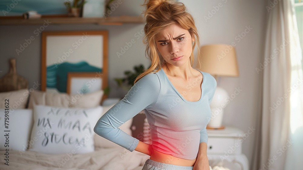 A woman with an expression of pain and suffering touching her back or the side of her belly. Kidney pain, back pain, appendicitis, back or rib pain. A woman with an expression of pain and suffering touching her back or the side of her belly. Kidney pain, back pain, appendicitis, back or rib pain.
