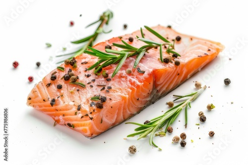 Fresh salmon slices with rosemary and black pepper isolated on white background.