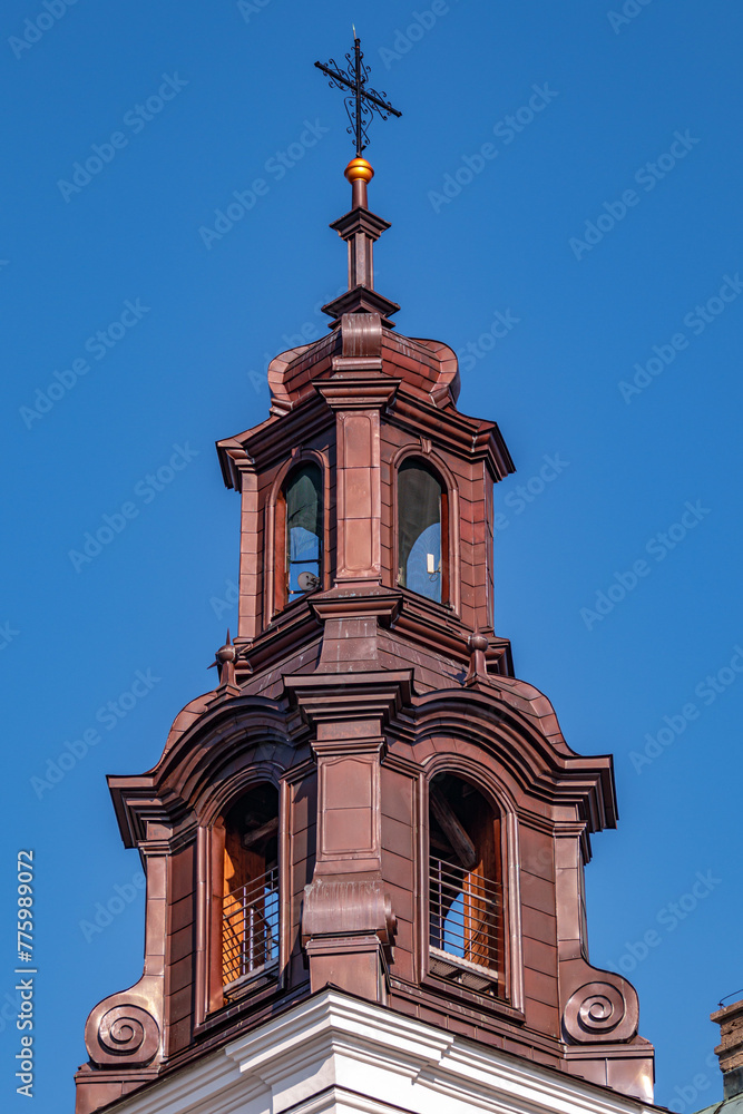 Beautiful view of a Catholic church tower under a blue sky