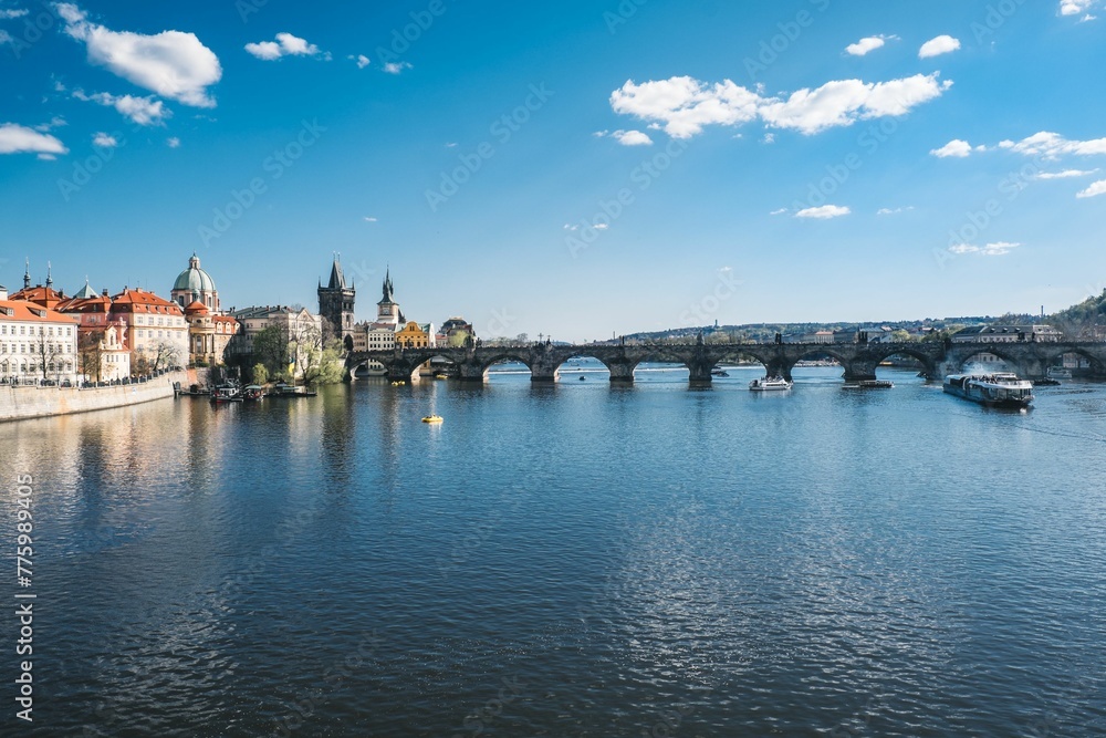 Beautiful shot of Charles Bridge and historic buildings across the water in Prague, Czech Republic