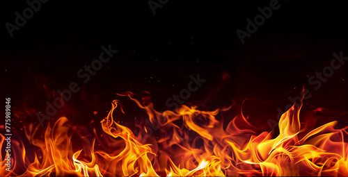 Massive fire burning in darkness. Seamless border with flame on a black background for banner. Red, orange, yellow colors.