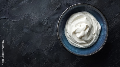 A minimalist top view of Greek yogurt served in a blue bowl