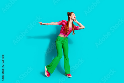 Full length photo of cool positive lady dressed pink knitted shirt dancing emtpy space isolated blue color background