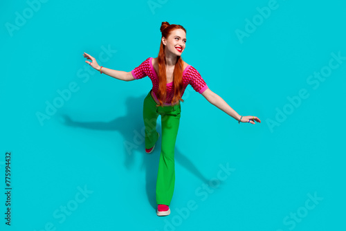 Full length photo of funky cheerful lady dressed pink knitted shirt dancing emtpy space isolated blue color background